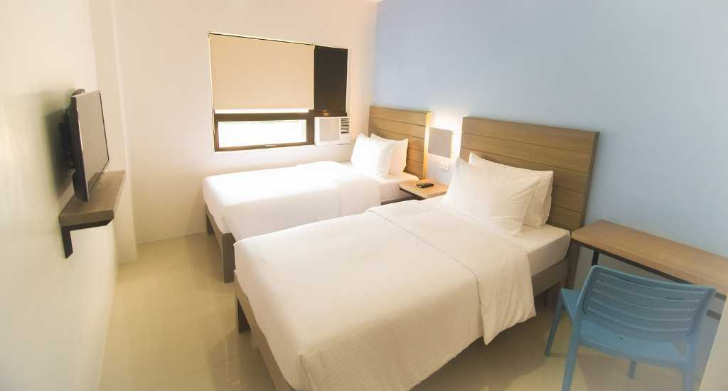 Twee eenpersoonsbedden in Felix Residences Cebu City